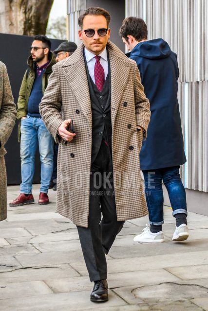 Men's winter coordinate and outfit with plain black sunglasses, brown check Ulster coat, plain white shirt, black plain toe leather shoes, plain dark gray three-piece suit, and red komon tie.