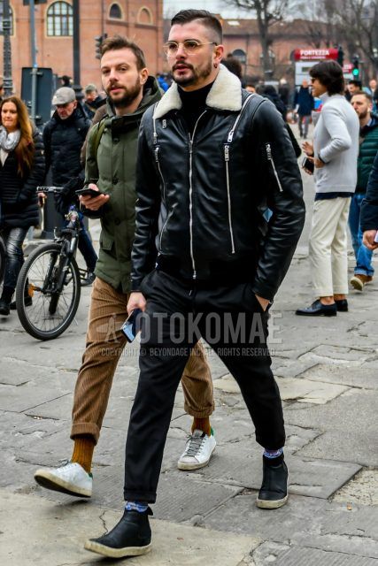 Men's coordinate and outfit with plain glasses, plain black leather jacket (other than rider's), plain black turtleneck knit, plain black easy pants, plain blue socks, and black high-cut sneakers.