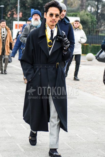 Men's coordinate and outfit with plain black and gold sunglasses, scarf/stall, plain black belted coat, plain white shirt, plain black socks, black loafer leather shoes, gray checked suit, and plain black tie.