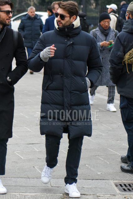 Men's coordinate and outfit with plain sunglasses, plain black down jacket, dark gray plain slacks, and white low-cut sneakers.