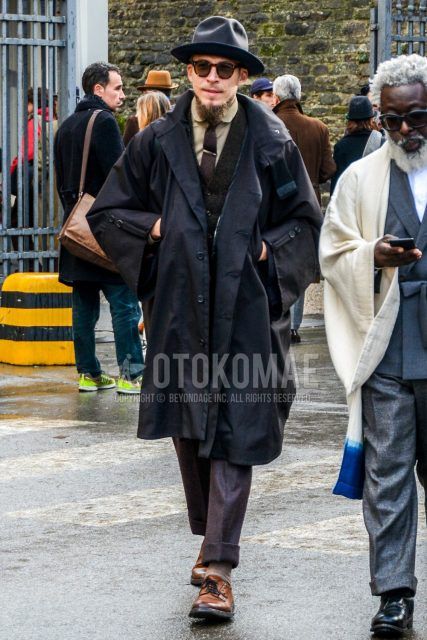 Men's coordinate and outfit with plain hat, plain sunglasses, plain black hooded coat, plain brown gilet, plain beige socks, plain brown plain toe leather shoes, and plain gray suit.