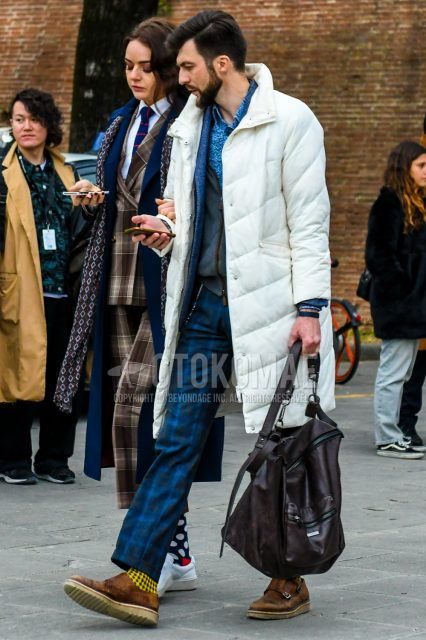 Plain white down jacket, blue top/inner shirt, plain gray casual vest, blue top/inner tailored jacket, navy check slacks, yellow check socks, brown monk shoe leather shoes, brown plain briefcase/ Men's coordinate/outfit with handbag.