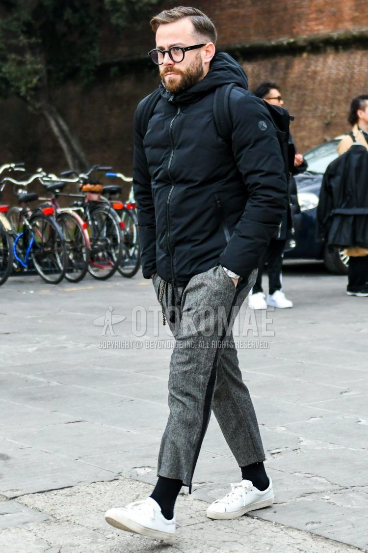 Men's coordinate and outfit with plain black glasses, plain black down jacket, plain gray sideline pants, plain gray ankle pants, plain black socks, and white low-cut sneakers.