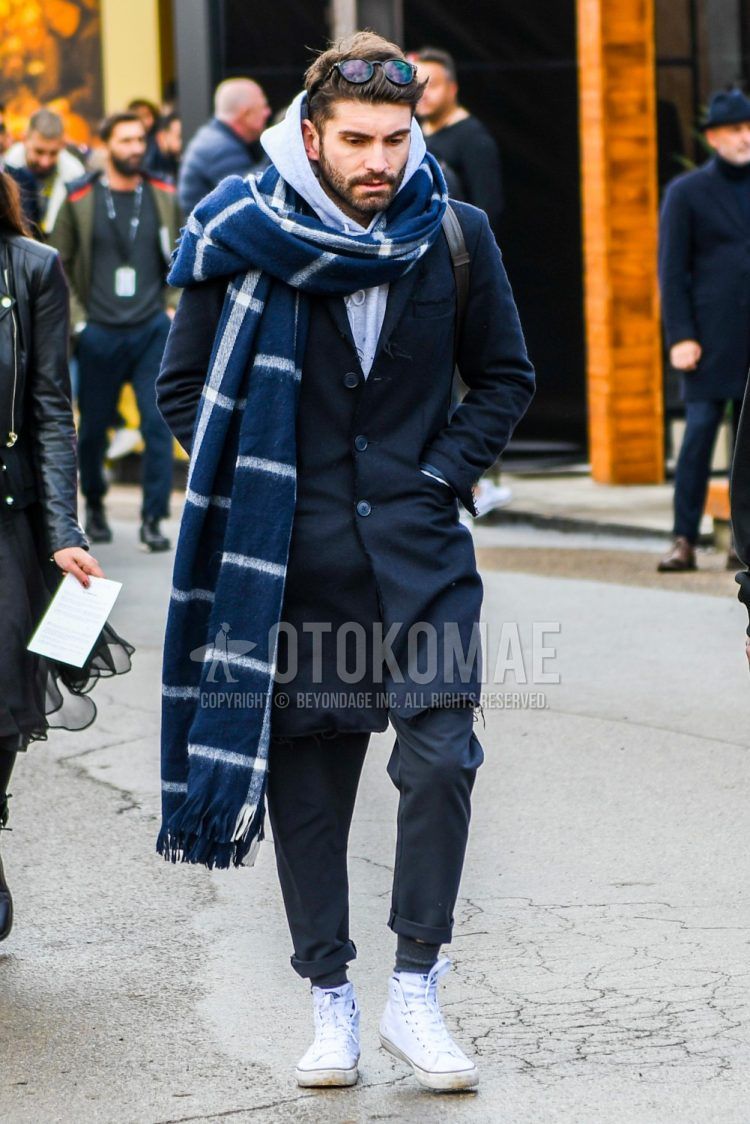 Men's coordinate and outfit with plain glasses, navy check scarf/stall, plain navy chester coat, plain gray hoodie, dark gray solid bottoms, dark gray solid socks, white high-cut sneakers.