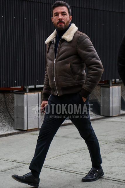 Men's coordinate and outfit with plain brown leather jacket (other than rider's), plain black turtleneck knit, plain gray slacks, plain black socks, and black monk leather shoes.