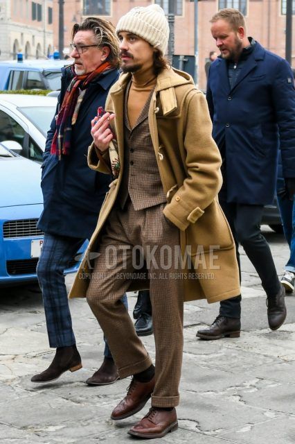 Men's coordinate and outfit with plain beige knit cap, plain beige duffle coat, brown check gilet, beige check turtleneck knit, beige check slacks, plain black socks, brown wingtip leather shoes.