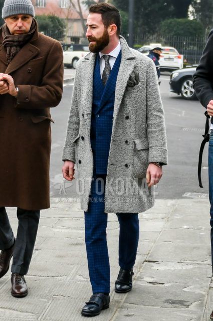 Men's coordination and outfit with plain gray Ulster coat, plain white shirt, black monk shoes leather shoes, blue checked suit, and gray tie tie.