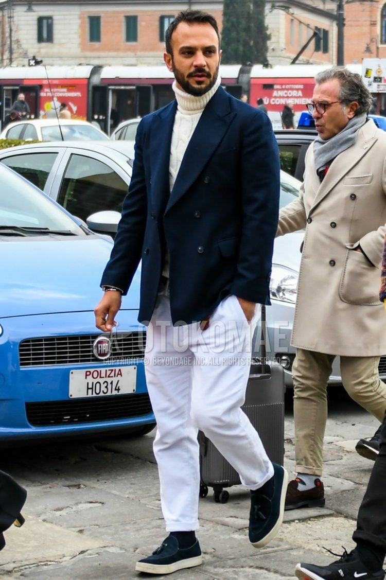 Men's coordinate and outfit with plain navy tailored jacket, plain white turtleneck knit, plain white cotton pants, plain black socks, and navy slip-on sneakers.