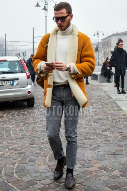 Men's coordinate and outfit with solid color sunglasses, solid color yellow leather jacket (not riders), solid color white turtleneck knit, solid color brown leather belt, solid color wool gray bottoms, solid color black socks, brown coin loafer leather shoes.