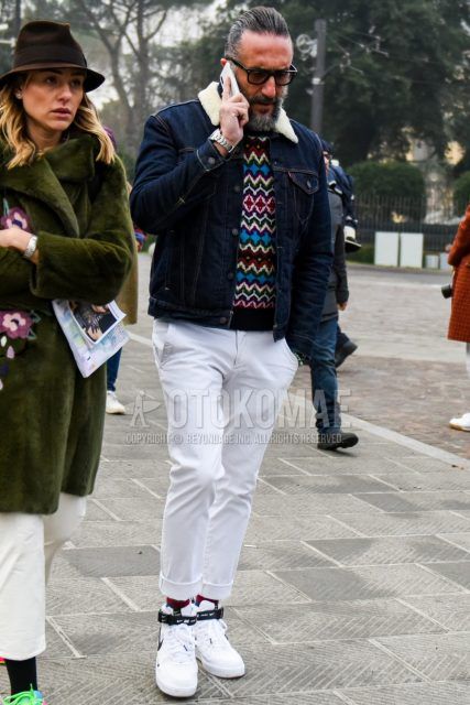 Men's coordinate and outfit with plain glasses, plain navy denim jacket, multi-colored top/inner sweater, plain white cotton pants, plain red socks, and Nike white high-cut sneakers.