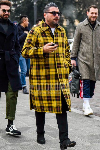 Men's winter coordinate and outfit with plain black sunglasses, yellow checked stainless steel coat, plain white t-shirt, plain black denim/jeans, and black boots.