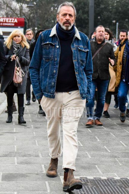 Men's coordinate and outfit with solid blue denim jacket, solid navy turtleneck knit, solid beige winter pants (corduroy,velour), and brown side gore boots.