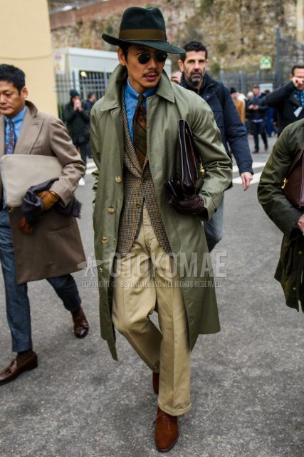 Solid green hat, round solid gold sunglasses, solid green stainless coat, solid blue denim/chambray shirt, brown checked tailored jacket, solid beige chinos, wide beige pants, suede brown wingtips Leather shoes, solid black clutch/second bag/drawstring, brown regimental tie.