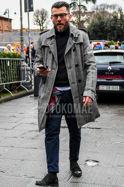 Winter men's coordinate and outfit with beige tortoiseshell glasses, glen check gray check trench coat, plain black turtleneck knit, dark gray plain socks, and black suede shoes leather shoes.