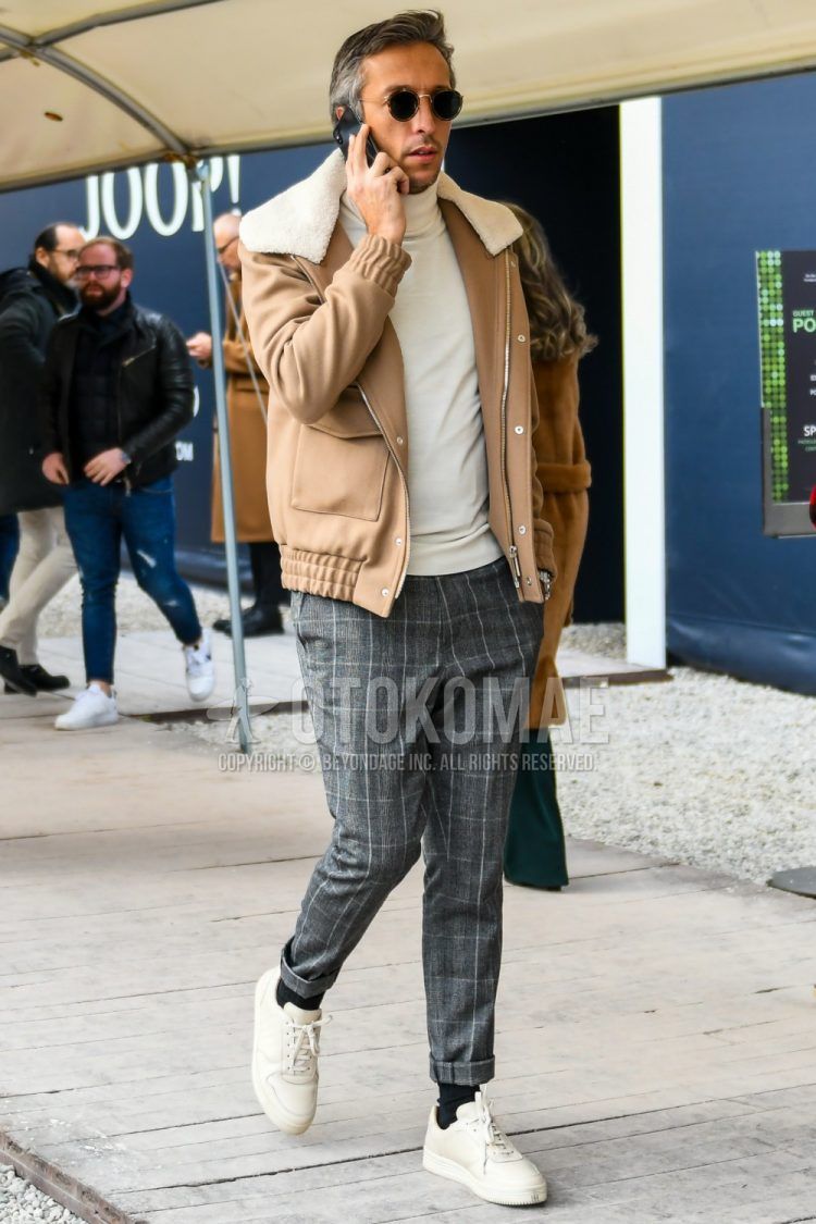 Men's coordinate and outfit with plain sunglasses, plain beige outerwear, plain white turtleneck knit, gray checked slacks, plain black socks, and white low-cut sneakers.