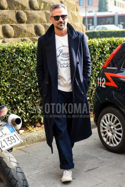 Men's coordinate and outfit with plain sunglasses, plain navy chester coat, plain white Loewe t-shirt, plain navy wide pants, and white high-cut Converse sneakers.