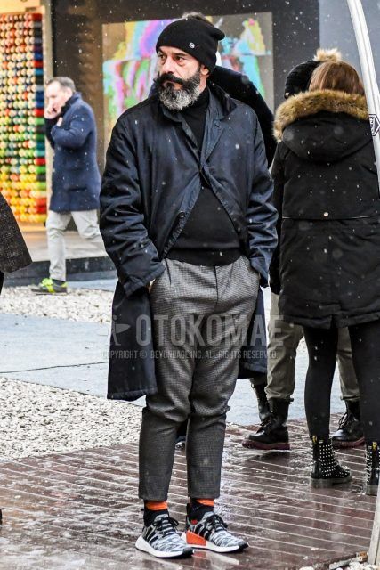 Men's coordinate and outfit with plain knit cap, plain black stainless steel collar coat, plain black turtleneck knit, gray checked slacks, plain orange socks, and Adidas NMD gray low-cut sneakers.