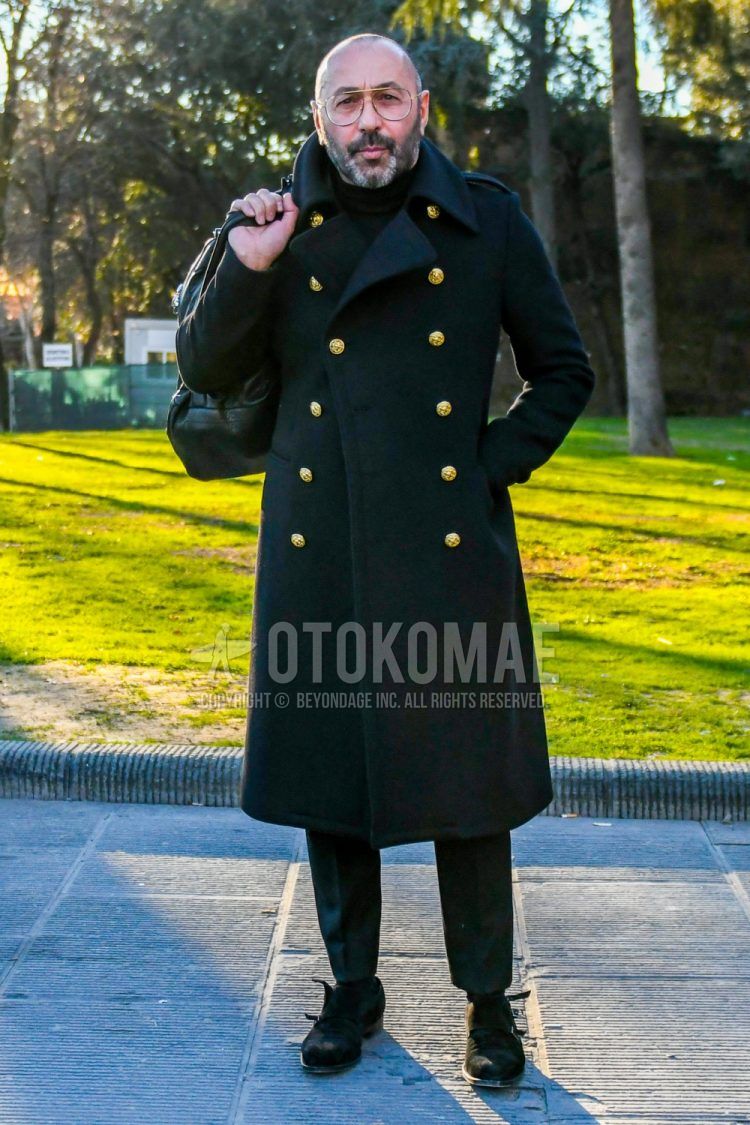 Men's winter coordinate and outfit with solid color glasses, solid color black outerwear, solid color black turtleneck knit, dark gray solid color slacks, suede brown monk leather shoes.
