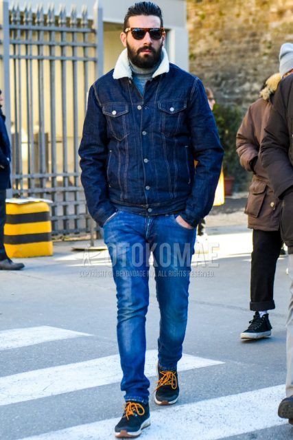 Men's coordinate and outfit with brown tortoiseshell sunglasses, solid navy denim jacket, solid gray turtleneck knit, solid blue denim/jeans, and black low-cut sneakers.