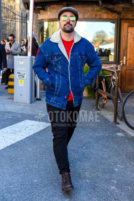 Men's coordinate and outfit with gray checked cap, teardrop solid silver sunglasses, solid blue denim jacket, solid red sweater, solid black damaged jeans, and brown work boots.