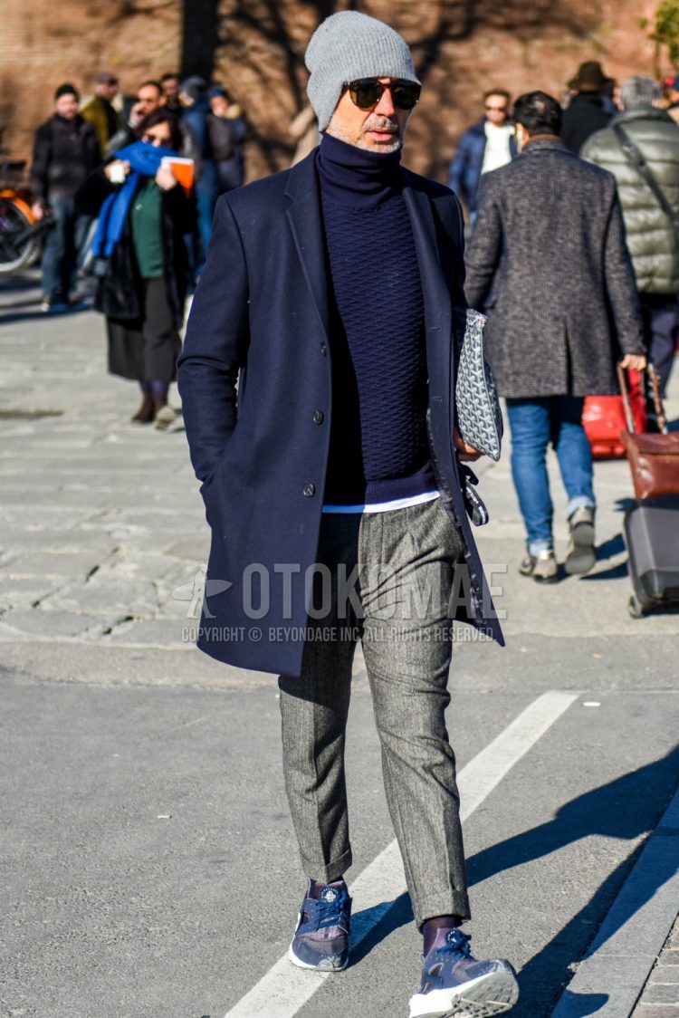 Solid gray knit cap, brown tortoiseshell sunglasses, solid navy chester coat, solid navy turtleneck knit, solid white t-shirt, solid gray slacks, solid gray pleated pants, solid black socks, Nike Air Harachi blue low cut sneakers. Men's coordinate and outfit.