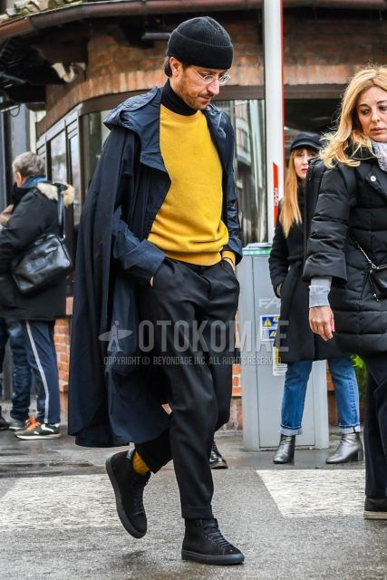Men's coordinate and outfit with solid black knit cap, solid black hooded coat, solid yellow sweater, solid black turtleneck knit, solid black bottoms, and black high-cut sneakers.
