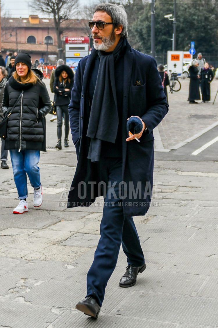 Men's coordinate and outfit with plain black sunglasses with teardrop Persol, plain dark gray scarf/stall, plain dark gray chester coat, plain gray turtleneck knit, plain dark gray slacks, and plain black brogue leather shoes.