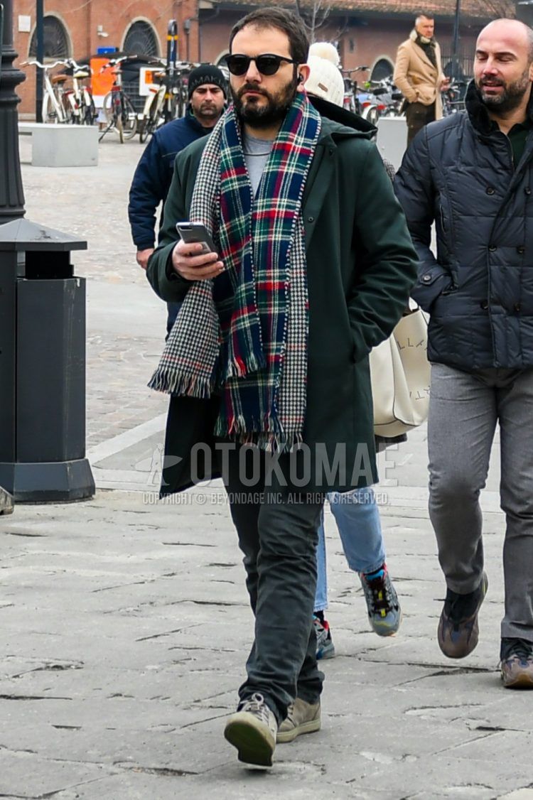 Men's coordinate and outfit with plain black sunglasses from Boston, multi-colored checked scarf/stall, dark gray solid color hooded coat, gray solid color t-shirt, gray solid color denim/jeans, gray low-cut sneakers.