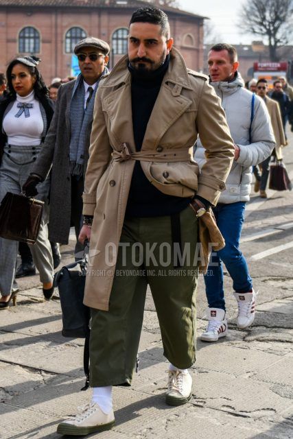 Men's coordinate and outfit with plain beige belted coat, plain black turtleneck knit, plain olive green wide pants, plain olive green chinos, plain white socks, and white low-cut sneakers.