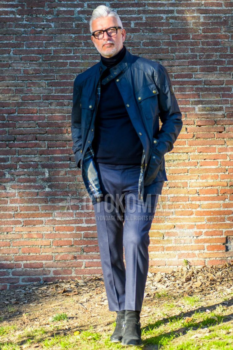 Men's coordinate and outfit with Tom Ford plain black glasses, Belstaff Roadmaster plain black rider's jacket, dark gray plain sweater, gray plain slacks, and black boots.