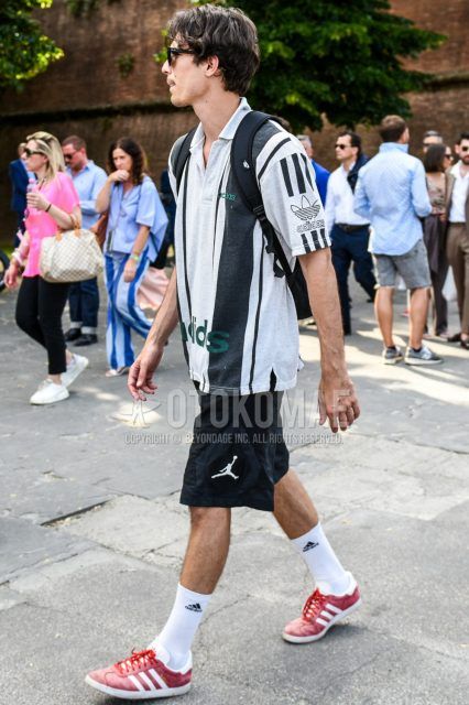 Men's summer coordinate and outfit with plain black Ray-Ban sunglasses, Adidas white top/inner polo shirt, Nike Jordan black one-pointed shorts, Adidas white one-pointed socks, and Adidas red low-cut sneakers.