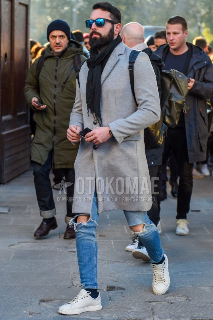 Men's fall/winter coordinate and outfit with plain black sunglasses, plain black scarf/stall, plain gray chester coat, plain light blue damaged jeans, plain navy socks, and white low-cut sneakers.