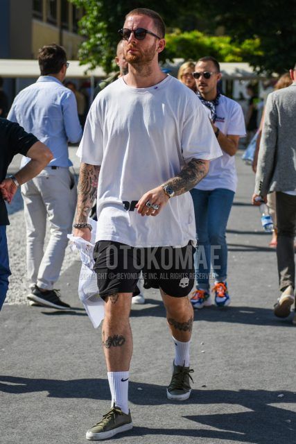 Men's coordinate and outfit with plain black sunglasses, plain white t-shirt, plain black shorts from Hydrogen, plain white socks from Nike, and olive green low-cut sneakers.