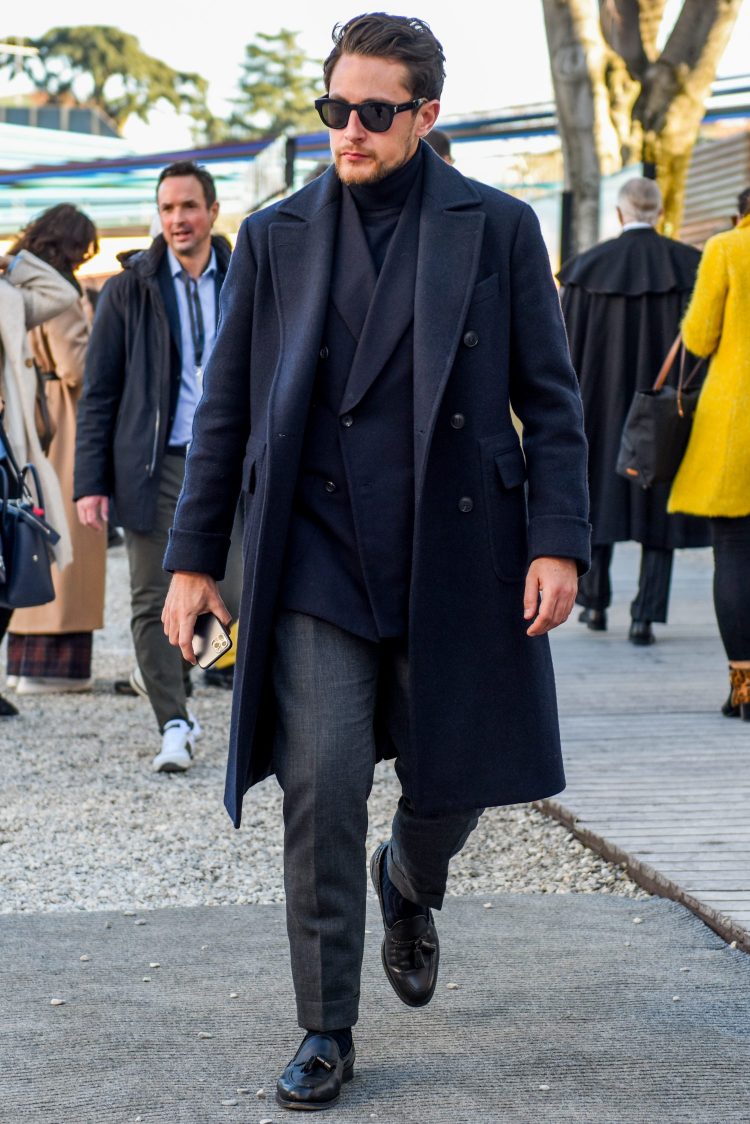 Navy jacket and gray slacks in a classic jacket style with black leather shoes for a chic look.
