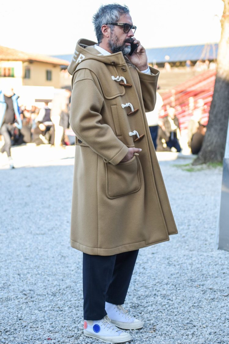 Mr. Daniele uses a big silhouette duffle coat to give his outfit a seasonal look.