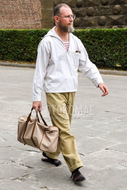 Men's coordination and outfit with plain glasses, plain white hoodie, white/red striped t-shirt, plain beige wide pants, plain navy socks, brown leather sandals, and plain beige Boston bag.