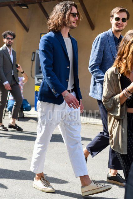 Men's coordinate and outfit with Thurmont Ray-Ban Clubmaster brown tortoiseshell sunglasses, plain blue tailored jacket, plain gray T-shirt, plain brown leather belt, plain white cotton pants, plain cropped pants, and white low-cut sneakers.