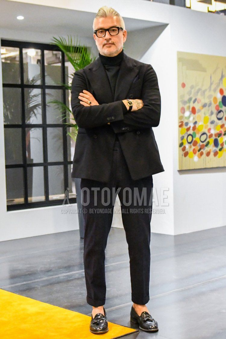 Men's coordinate and outfit with plain glasses, plain black tailored jacket, plain black turtleneck knit, plain black slacks, and black tassel loafer leather shoes.