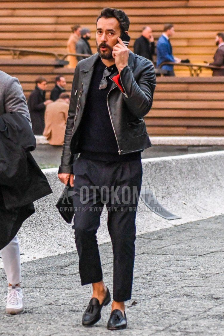 Men's coordinate and outfit with plain black rider's jacket, plain black sweater, plain black slacks, and black tassel loafer leather shoes.