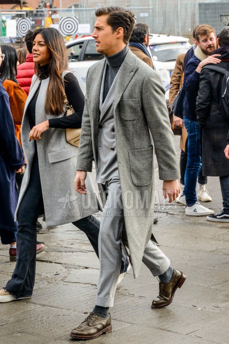 Men's coordinate and outfit with glen check gray checkered chester coat, plain gray turtleneck knit, plain gray socks, brown wingtip leather shoes, and plain gray suit.
