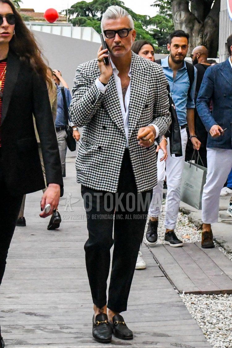 Men's coordinate and outfit with plain sunglasses, white/black checked tailored jacket, plain white shirt, plain black slacks, and black bit loafer leather shoes.