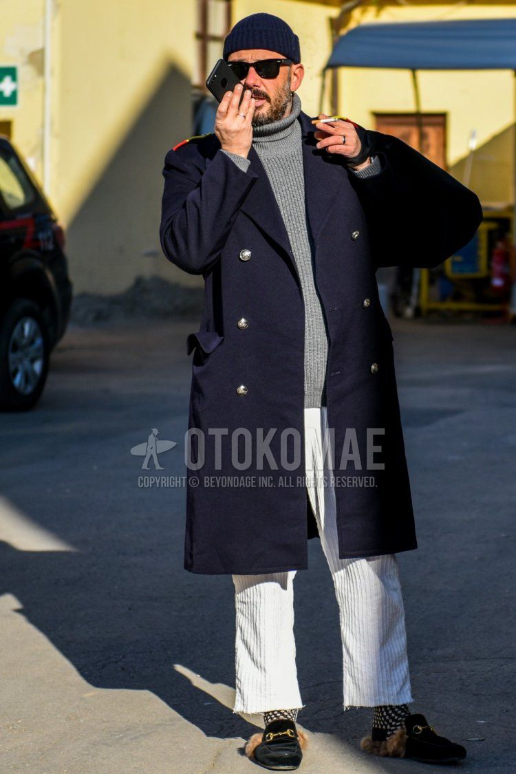 Solid navy knit cap, Ray-Ban Wayfarer Wellington solid black sunglasses, solid navy Ulster coat, solid gray turtleneck knit, solid white winter pants (corduroy, velour), beige and black socks, black bit loafer leather shoes Men's winter coordinate and outfit.