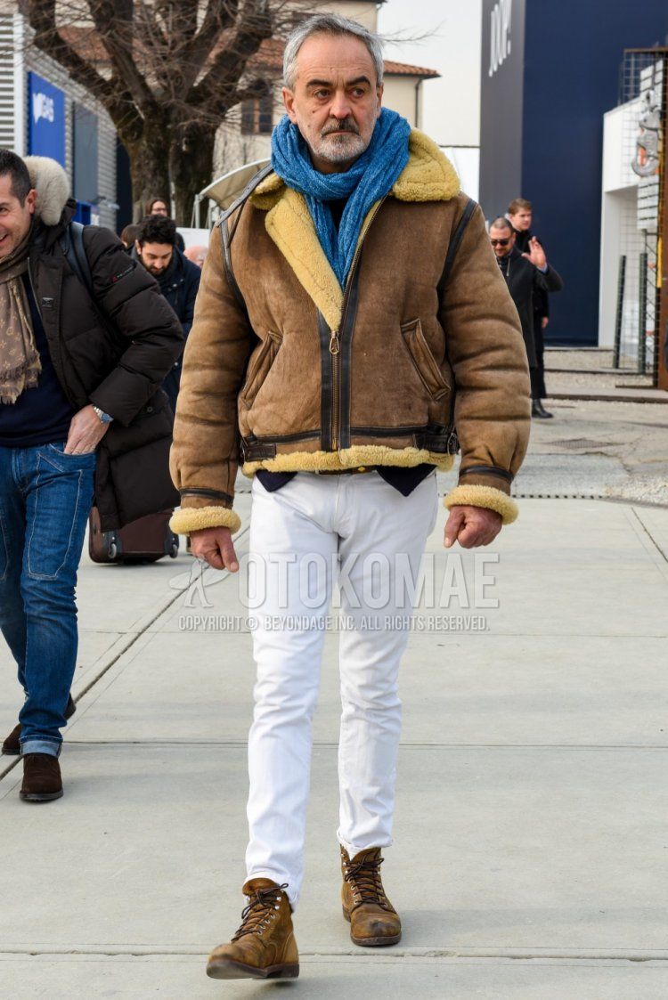 Men's fall/winter outfit/coordination with light blue solid color scarf/stall, brown solid color leather jacket (not riders), white solid color cotton pants, and brown work boots.