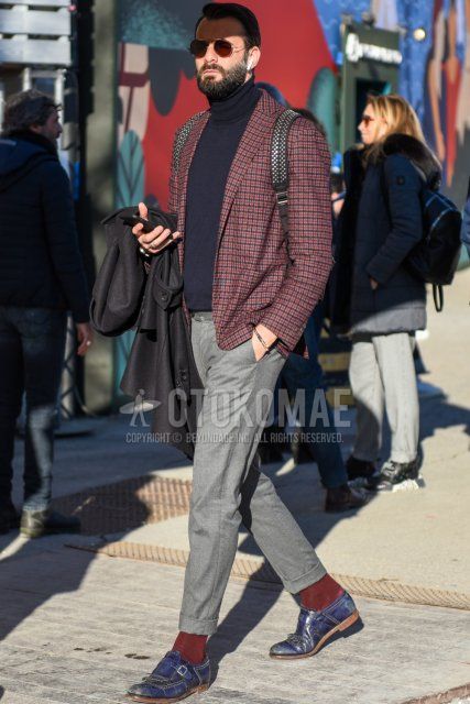 Spring and fall men's coordinate and outfit with plain silver sunglasses, red navy check tailored jacket, plain dark gray turtleneck knit, solid gray slacks, solid gray cropped pants, solid red socks, and navy monk leather shoes.