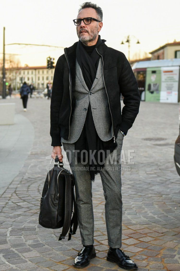 Men's fall/winter coordinate and outfit with plain black glasses, plain black scarf/stall, plain black outerwear, plain black socks, black monk shoes leather shoes, plain black backpack, and gray checked suit.