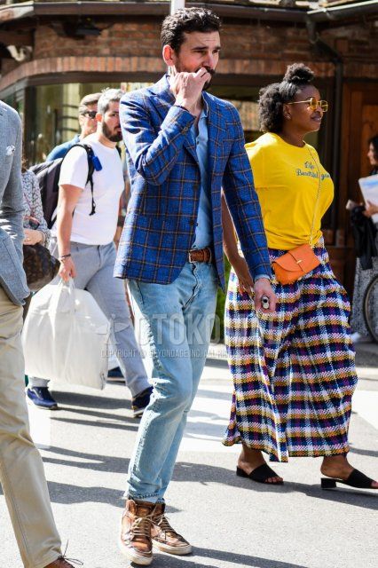 Men's coordination and outfit with gray checked tailored jacket, light blue solid denim/chambray shirt, brown solid leather belt, light blue solid denim/jeans, and brown sneakers.
