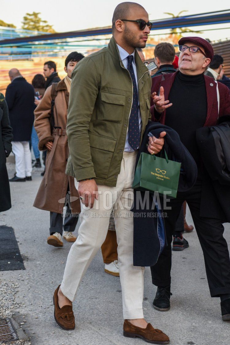 Men's fall/winter outfit with solid black sunglasses, solid olive green M-65, solid white shirt, solid beige beltless pants, solid beige ankle pants, solid beige slacks, suede brown tassel loafer leather shoes, gray dot tie ...and a gray dot tie.
