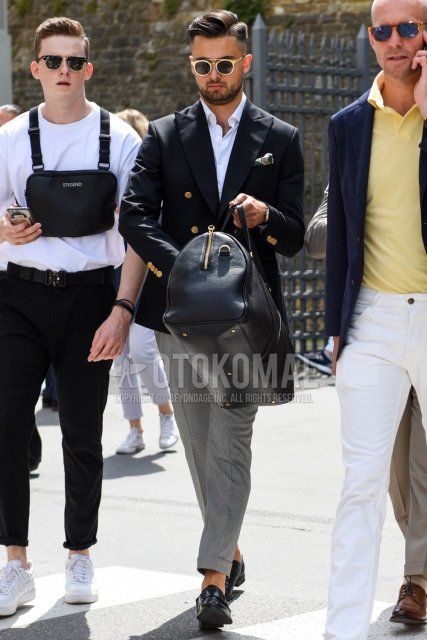 Men's coordinate and outfit with plain gold and black sunglasses, plain black tailored jacket, plain white shirt, plain gray slacks, and black coin loafer leather shoes.