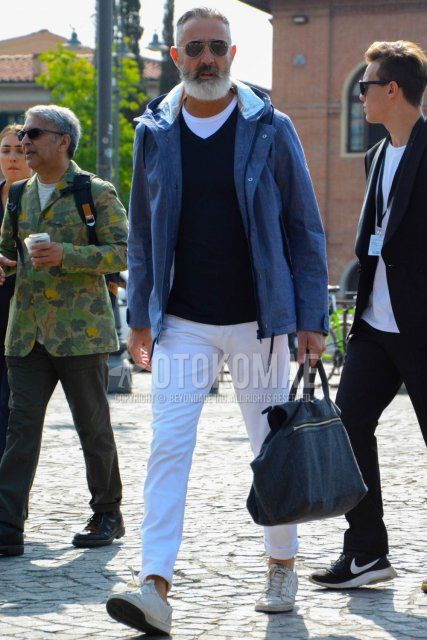 Men's coordinate and outfit with plain sunglasses, plain gray mountain parka, plain black sweater, plain white t-shirt, plain white denim/jeans, white low-cut sneakers, and plain gray Boston bag.