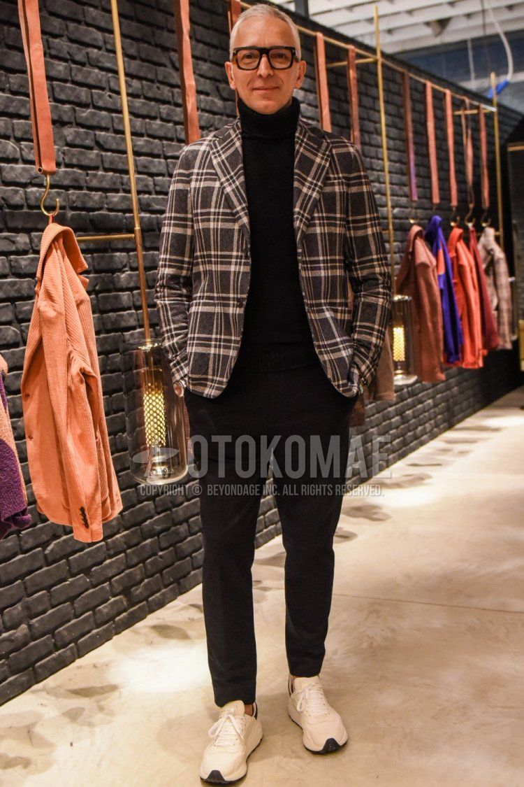 Men's fall/spring outfit with Tom Ford brown tortoiseshell glasses, gray checked tailored jacket, solid black turtleneck knit, solid gray slacks, solid gray ankle pants, and white low-cut sneakers.